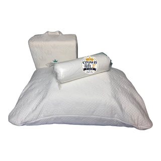 A white quilted pillow with a matching cylindrical pillow wrapped in plastic, featuring a 'crown fit' brand label, set against a plain white background. The 2 inch add-on firm support core is resting on top of the pocket pillowcase with a support core inserted inside and a pillow.