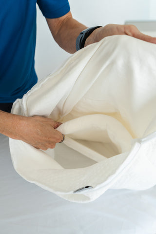Sliding a Crown Lift LiftCore support core into the pocket pillowcase.